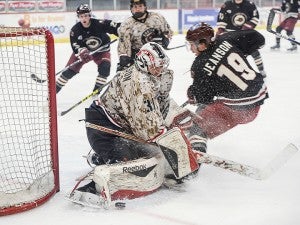 Goalie Kristofer Carlson makes a stop on Minot’s Tyler Jeanson during the first period Friday night at Riverside Arena. — Eric Johnson/Albert Lea Tribune