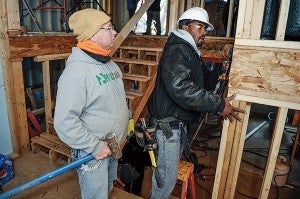 Riverland Community College carpentry student Phillip Gills uses a nailgun as instructor Tom Wilker watches at a Habitat for Humanity remodel project. It’s part of a partnership between the two organizations. — Eric Johnson/Albert Lea Tribune