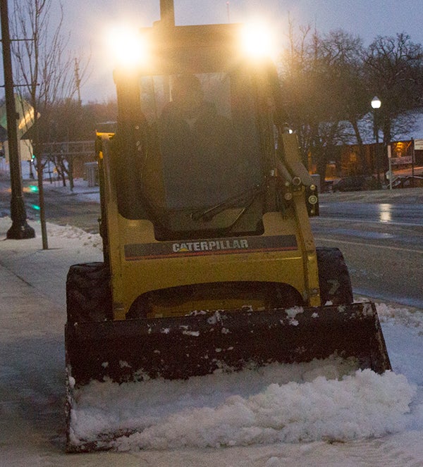 Snow is cleared from the sidewalk in front of the Freeborn County Government Center. - Sam Wilmes/Albert Lea Tribune