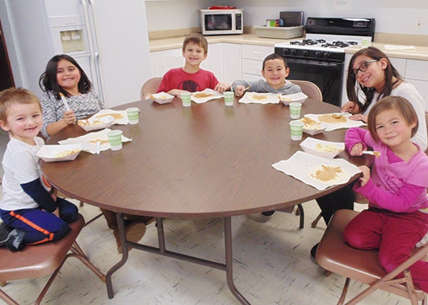 Students enjoy a snack during an after school program at St. Casimir’s Catholic School. - Provided