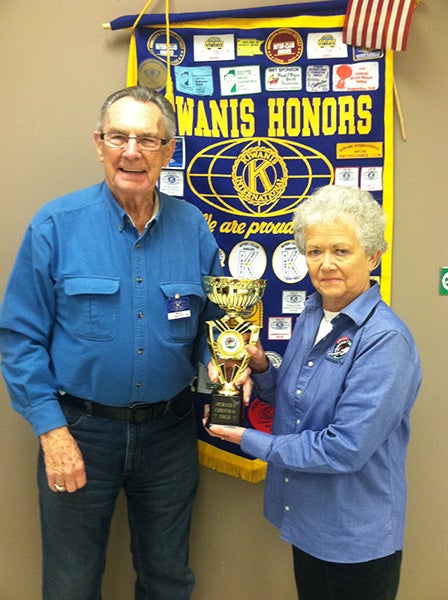 Rose Olson presents the Operation Christmas Child shoebox traveling trophy to Dick Polley of the Day Breakers Kiwanis Club. - Provided