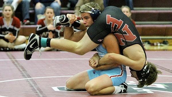Albert Lea’s Garrett Aldrich wrestles New Prague’s Brady O’Neill Saturday at a tournament at New Prague. Aldrich, ranked No. 1 at 126 pounds in Class A, won with a 5-2 decision. — Pam Nelson/for the Albert Lea Tribune