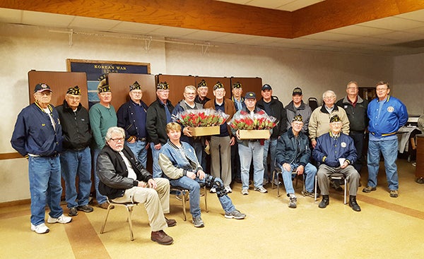 American Legion Post 56 volunteers deliver 120 poinsettia plants to military veterans residing in area nursing homes, care facilities and retirement communities on Saturday. - Provided