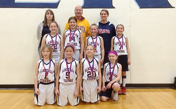 The Albert Lea fourth-grade girls’ basketball team took third place Dec. 5 in a four-team round-robin tournament at Albert Lea. The Tigers beat New Prague 14-12 in triple overtime to take third. Front row from left are Jalen Boss, Alexis Jones, Elizabeth Wallace and Ahnnalie Hill. Middle row from left are Alyssa Jensen, Emily Komoszewski, Nevaeh Wacholz and Hannah Willner. Back row from left are coaches Danielle Boss, Tom Jones and Afton Wacholz. Olivia Wegner was not pictured. Provided