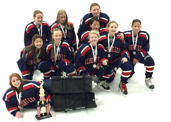 The Albert Lea U12B girls’ hockey team poses with a trophy after finishing third at the Hastings Invitational, a tournament that spanned Dec. 5 and 6. Front row is Emma Piechowski. Middle row from left are Alli Dulitz, Josie Venem, Hannah Adams, Jaiden Venem and Lucy Stay. Back row from left are Katie Uthke, Emilee Schmitt, Esther Yoon and Taylor Stanek. Malana Thompson is not pictured. - Provided
