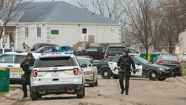 Law enforcement officials dressed in tactical gear walk to their vehicles after executing a "high-risk arrest warrant" Tuesday at the Gracious Estates development on the 700 block of South Eisenhower Avenue in Mason City. Officials reported one arrest and no injuries during the operation. — Chris Zoeller/The Globe Gazette