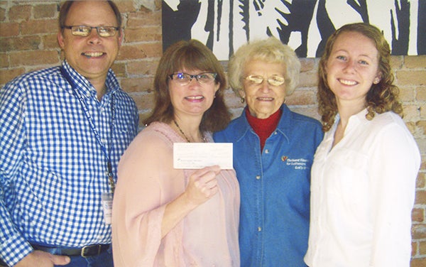 Greg and Robin Gudal left, and Mindy Holstad, far right, receive a check for $623 to Youth For Christ from Joyce Fredin of the Freeborn County Chapter of Thrivent. -Provided