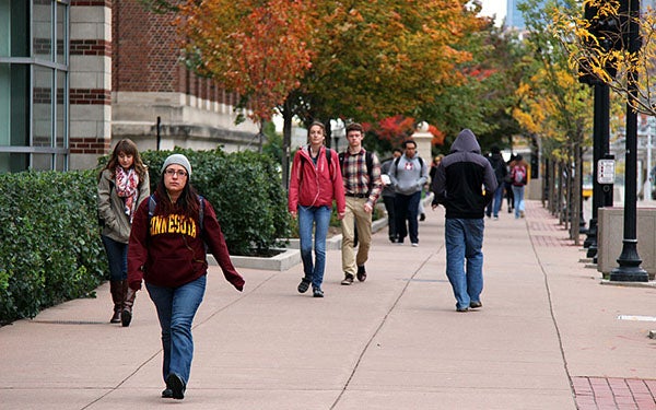 A health survey from the University of Minnesota shows that while high-risk drinking and smoking rates are down, the number of students reporting mental health conditions and sexual assaults have climbed. Here, university students and workers walked through the Minneapolis campus on Oct. 12. Russell Barnes/MPR News