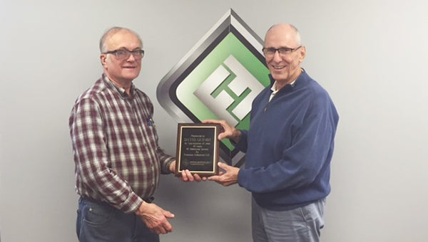 Bill Dea, right, president and CEO of Fountain Industries LLC., presents David Quindt with a plaque in appreciation of 45 years of service at Fountain Industries LLC. Along with the plaque, a luncheon and gift were also presented with Quindt’s family and coworkers attending. Fountain Industries LLC is the leading manufacturer of automotive and industrial parts washers in the country and has been in business in Albert Lea since 1966. — Provided