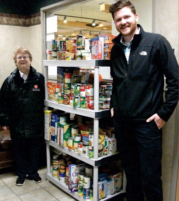 This holiday season, the employees of Trail’s Travel Center collected food donations for the local Salvation Army food pantry to help feed the need in our community. Pictured is Dustin Trail, general manager at Trail’s Travel Center, presents Salvation Army Maj. Elsie Cline with over 300 food item donations. — Provided