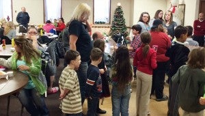 Children and parents socialize at the Christmas party for children at American Legion Post 56. — Provided