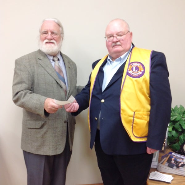  Albert Lea Cloverleaf  Lions President Tom Schleck, right, presents a check to for $100 to Perry Virnig, left, for youth rendezvous programs. - Provided