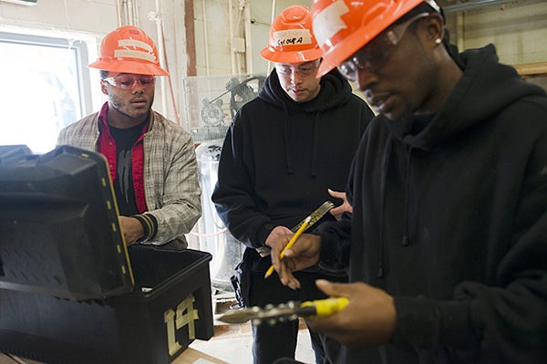 New students in the hand and power tool class go through the tool inventory to familiarize themselves with the toolbox they will use Nov. 23 at Summit Academy OIC in Minneapolis on. — Matthew Hintz/for MPR News 