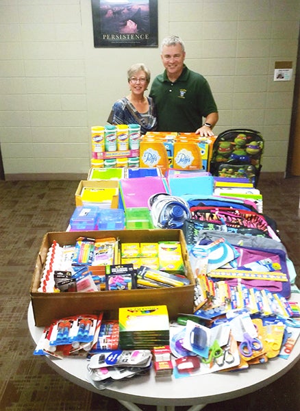 Superintendent of Albert Lea Area Schools Mike Funk receives $1,052 in back-to-school supplies from American Legion Auxiliary Post No. 56 of Albert Lea. Children and Youth Chairwoman Karen Cibert was pleased with the donations and plans to hold their third drive in 2016. - Provided