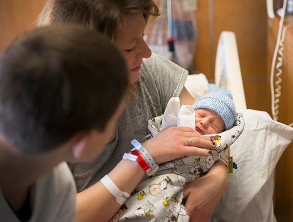 Jenny VanGerpen holds her newborn son, Odin Mark Bromeland, as her older son, Brody Bromeland, looks at his new brother. Odin Bromeland was born Fridayu at Mayo Clinic Health System in Albert Lea. - Colleen Harrison/Albert Lea Tribune