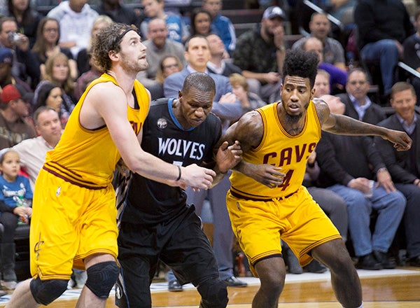 Cleveland's Kevin Love and Iman Shumpert guard Minnesota's Gorgui Dieng during Friday's game at Target Center in Minneapolis. - Colleen Harrison/Albert Lea Tribune