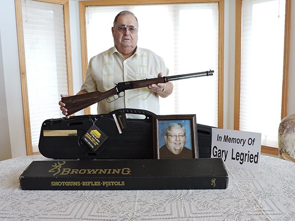 Orville Johnson purchased a Browning 22 rifle that will be auctioned off at the Geneva Cancer Auction in memory of his friend Gary Legried. The rifle, shipping case and hard body case are all being donated in Legried’s honor. - Kelly Wassenberg/Albert Lea Tribune