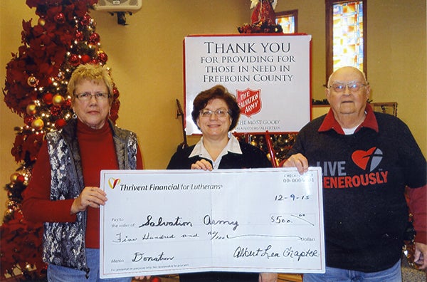 Hazel Spiering, left, and Les Anderson, right, of Thrivent Financial for Lutherans present a donation to Maj. Louise Delano-Sharp of The Salvation Army. - Provided