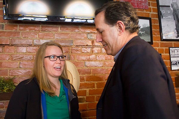 Becca Schwartz discusses politics with Rick Santorum Wednesday morning at Teluwut.  - Sam Wilmes/Albert Lea Tribune