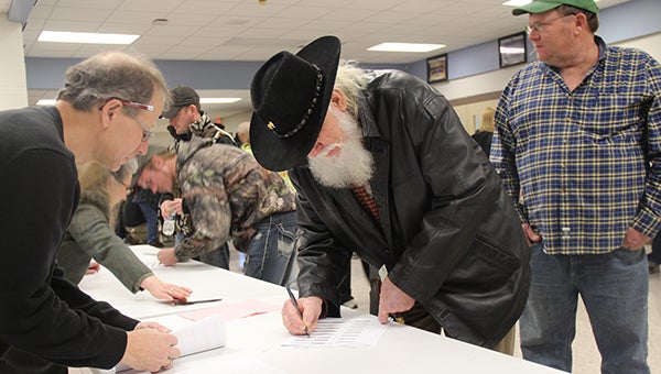 Jack VanHorn signs in at the Worthy County Republican caucuses Monday night at Central Springs High School in Manly. VanHorn said it was his first time participating in a caucus. — Sarah Stultz/Albert Lea Tribune
