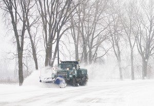 A snow plow clears a roadway near Frank Hall Park Tuesday as the area had to dig itself out of 6 inches of snow that fell throughout the morning and afternoon. - Colleen Harrison/Albert Lea Tribune