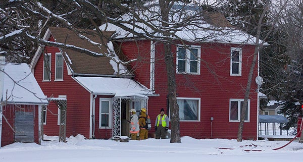 Firefighters look to penetrate the house Thursday in Manchester. - Sam Wilmes/Albert Lea Tribune