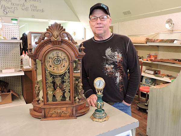 Jeff Johnson’s shop has about 100 clocks in it, including the larger clock pictured, which was originally purchased by its first owner in 1892. -Kelly Wassenberg/Albert Lea Tribune