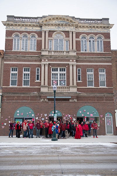 People gather to celebrate the 100th anniversary of the historic Bessesen building in downtown Albert Lea by wearing red and "heart bombing" the building. The event was organized by the Freeborn County Arts Initiative in conjunction with the Preservation Alliance of Minnesota to draw attention to historic buildings. Colleen Harrison/Albert Lea Tribune