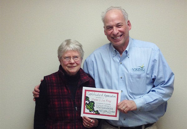 Maren Ring and Tom Ehrhardt are presented with recognition awards at the 40th annual meeting of Wintergreen Natural Foods membership for their many years of service and commitment. -Provided