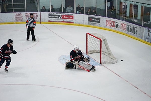 Albert Lea goalie Ben Witham deflects a shot into the corner during Thursday’s Section 1A semifinal game against Mankato West. Witham made 37 saves in the Tigers’ 2-1 double-overtime loss to the Scarlets. - James Eaton/For the Albert Lea Tribune