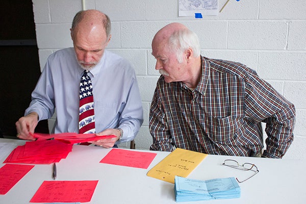 Volunteers John Holt and Wayne Griffith count votes Tuesday night during the Freeborn County Republican Caucus. - Sam Wilmes/Albert Lea Tribune