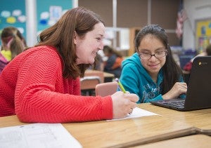 Fifth-grade teacher Melissa Schmidt helps student Maria Flores with schoolwork Thursday in her classroom at Halverson Elementary School. - Colleen Harrison/Albert Lea Tribune