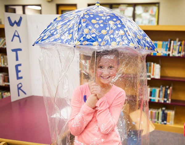 Third-grader Mikayla Clough shows off her water shield during Lake Mills' invention fair on Tuesday. Colleen Harrison/Albert Lea Tribune