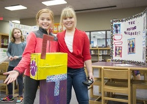 Lake Mills third-graders Bailey Dagestad, left, and Natalie Nyguard pose with their invention — a moving mailbox — during Tuesday's invention fair. - Colleen Harrison/Albert Lea Tribune