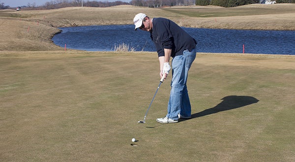 Chad Vogt putts Friday afternoon at Wedgewood Cove, the first day the course was open for the season. -Sam Wilmes/Albert Lea Tribune