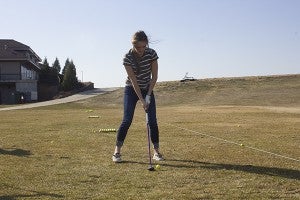 Albert Lea High School junior Claire Sherman tees off on the driving range Friday at Wedgewood Cove Golf Course. - Sam Wilmes/Albert Lea Tribune