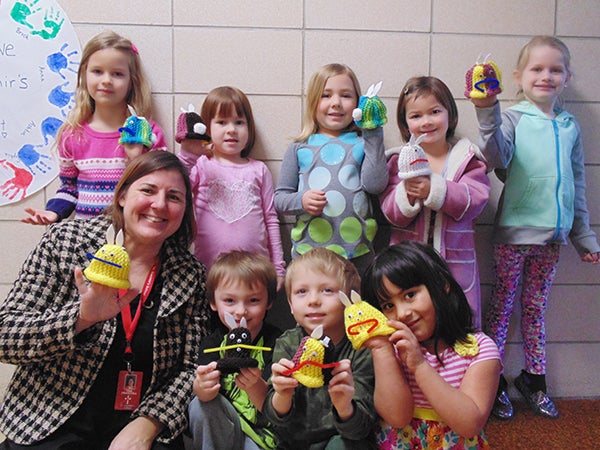 St. Casimir’s Catholic School pre-kindergarten students and their teacher show the knitted thank you bunnies they received as a gift. -Provided