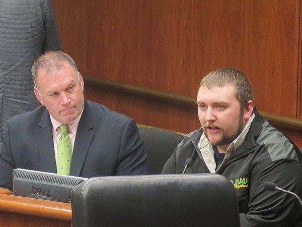 Sam Romain of Haug Implement in Willmar testifies Thursday about frustrations with slow Internet speeds in rural Minnesota as Rep. Dave Baker, R-Willmar, looks on. -Brian Bakst/MPR News