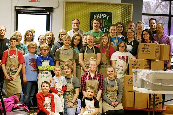 Hayward 4-H club members, leaders and family members packed meals with Real Hope for the Hungry at the Veterans of Foreign Wars in Austin before their monthly meeting this week. Club members also brought canned and other food items to share with the local food shelf. -Provided