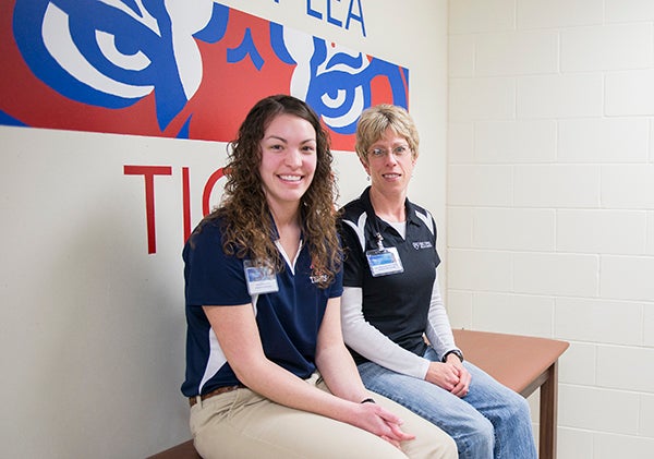 Lynn Rothmeier, right, and Emily Seiler are certified athletic trainers who work out of HealthReach through Mayo Clinic Health System in Albert Lea and Austin. Their primary work site is Albert Lea High School. - Colleen Harrison/Albert Lea Tribune