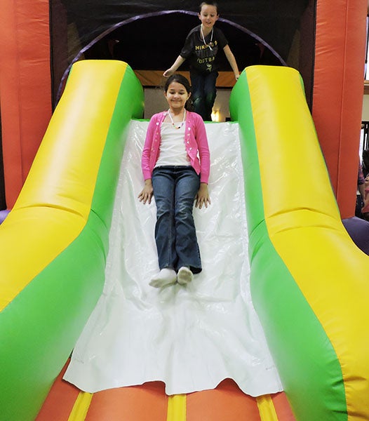 Maria Cantu, 9, plays on an inflatable slide Sunday afternoon at Crossroads Church’s FunFest. - Sam Wilmes/Albert Lea Tribune  