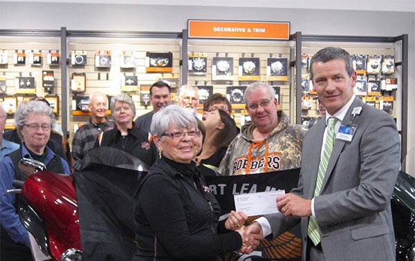 Mark Ciota, right, presents a check for $1,000 from the Mayo Foundation for Medical Education and Research to Judy Renwick, Harley Owner’s Group volunteer for the Nation of Patriots. - Provided