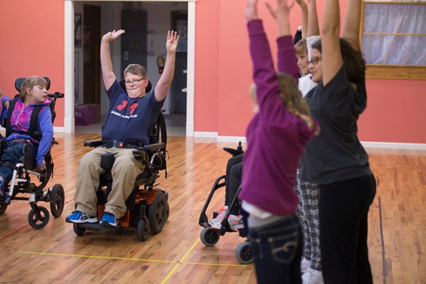 Hunter Johnson does some warmup stretches during an adaptive dance class at Just For Kix in Albert Lea. — Colleen Harrison/Albert Lea Tribune