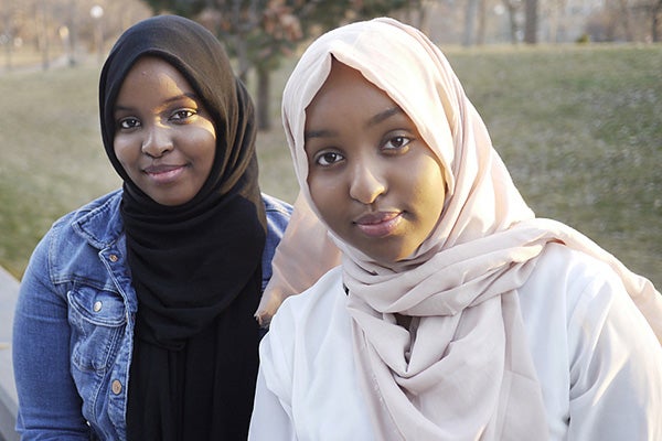 Sisters Khulud Hassan, left, and Zeinab Hassan of Mankato say they support federal and private dollars to help Somali youth. Doualy Xaykaothao/MPR News 