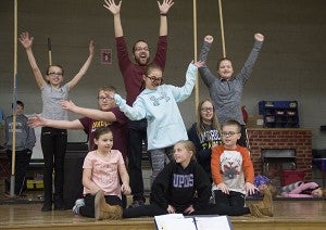 Hawthorne Elementary School students and Thomas Squires, director from Prairie Fire Children’s Theatre who also plays the parts of Geppetto and Tempesto, practice a scene from “PInocchio” Wednesday at the school. - Sarah Stultz/Albert Lea Tribune
