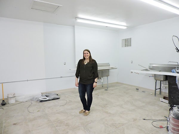 Lacey Hassing stands in the middle of what will be her kitchen once Lacey’s Catering’s renovations are complete. - Kelly Wassenberg/Albert Lea Tribune