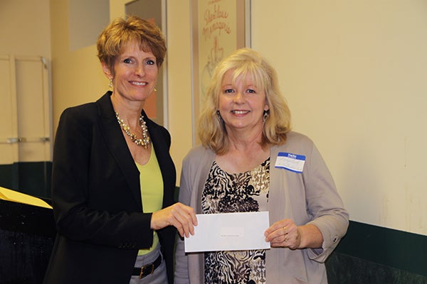 Jillian Peterson, board chairwoman of the Freeborn County Community Foundation, presents Mary Goetz, from The Arc of Freeborn County, with a donation. - Provided 
