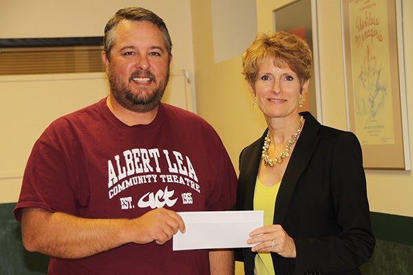 Jason Howland from Albert Lea Community Theatre accepts a check from Jillian Peterson, board chairwoman of the Freeborn County Community Foundation. - Provided