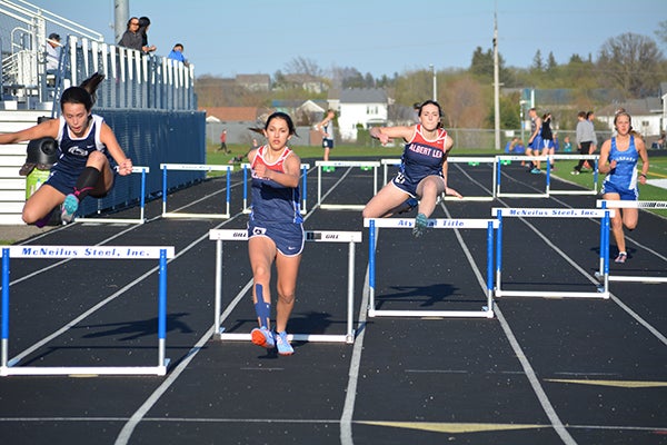 Albert Lea’s Alexis Tasker and Alexis Palomo compete in a hurdles event Friday at Kasson-Mantorville. - Lon Nelson/For the Albert Lea Tribune