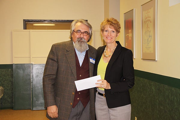 Lyle Jensen from Tentmakers in Chanhassen accepts a donation from Jill Peterson, chairwoman of the Freeborn County Community Foundation. Provided
